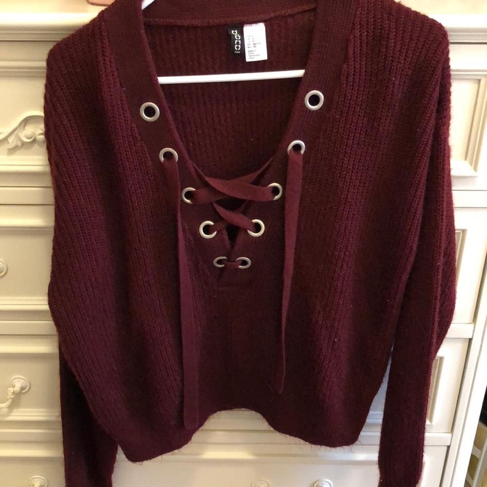 Maroon sweater with crossing strings